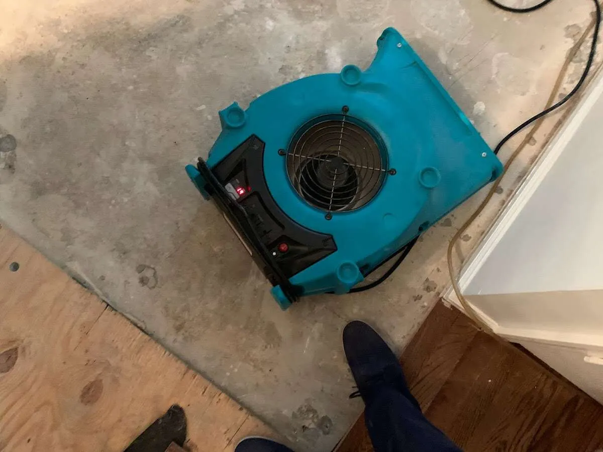 Air mover drying subfloor during Commercial Water Damage Restoration in Island Lake